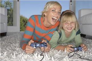 female business owner with her daughter enjoying recreational time playing video games on the tv in their living room